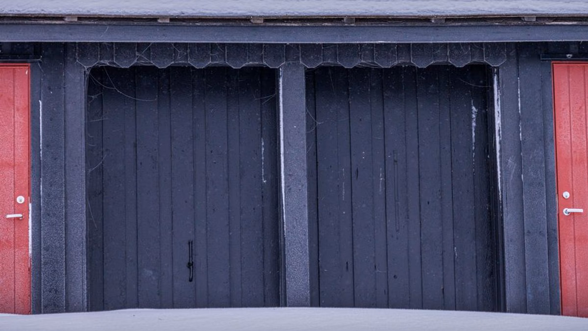 Garden shed with snow on the roof — typical winter storage before a strimmer no-start in spring