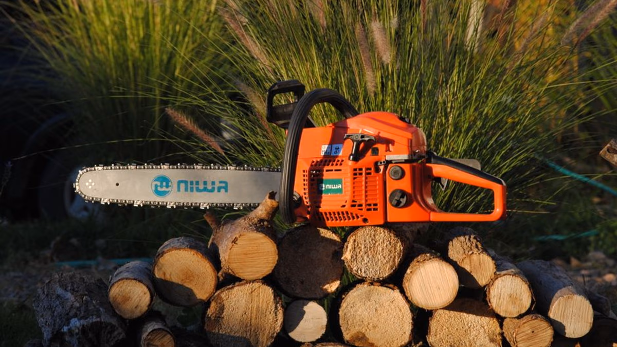 Petrol chainsaw in use — Husqvarna primer, carb and bar oil faults are common