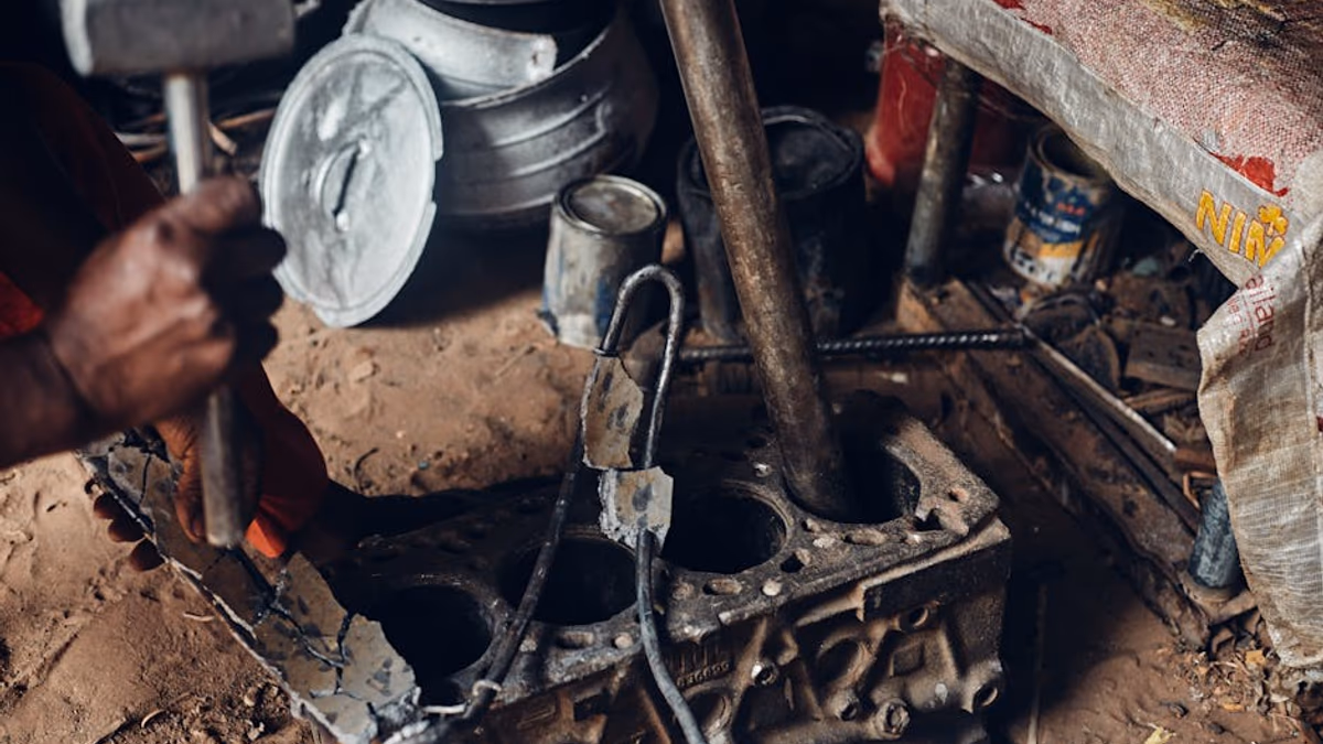 Mobile mechanic repairing garden machinery on-site