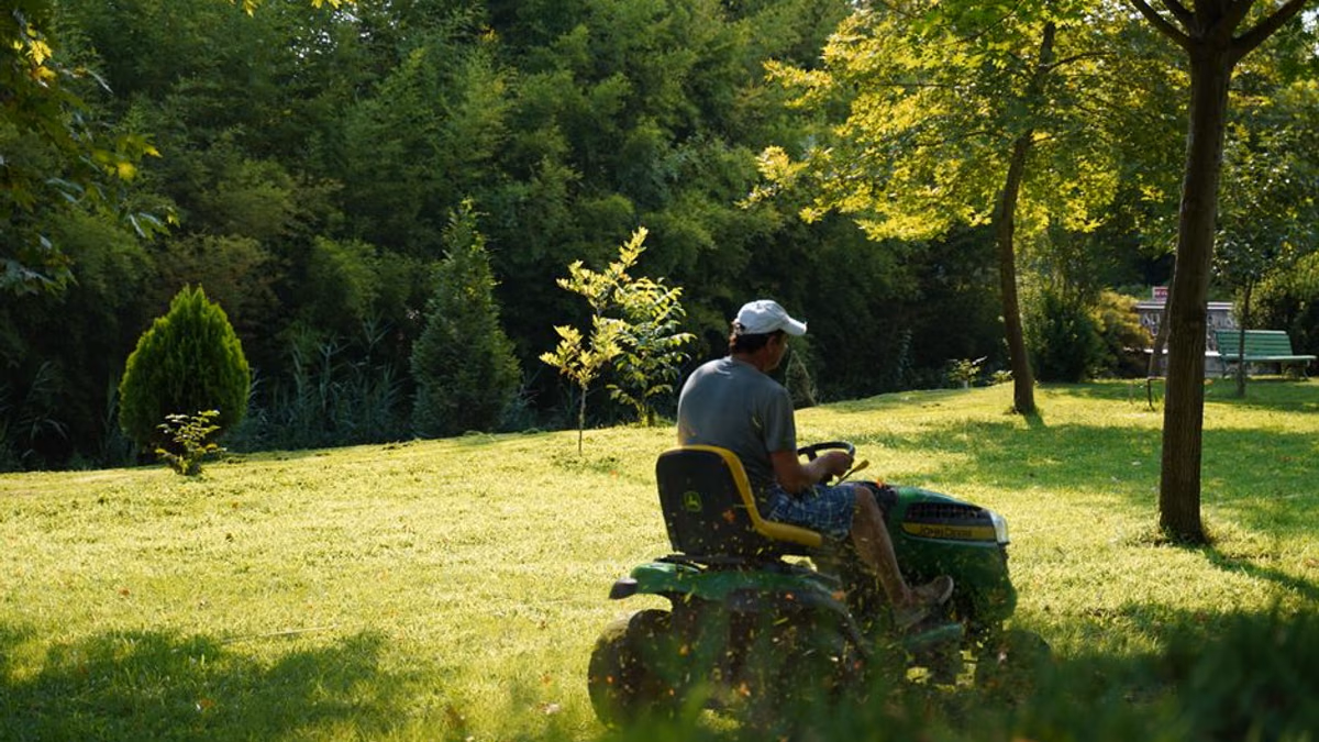 Ride-on garden tractor on a lawn — starting, drive and deck faults need separate checks