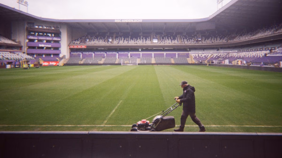Sports ground being mowed with professional grounds equipment