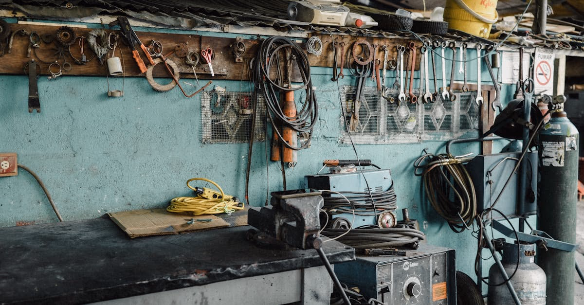 A mechanic workshop with hand tools and machinery arranged on a workbench